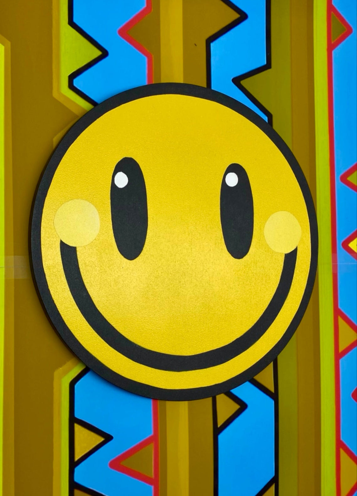 Smiley circular spray painting displayed on Dawn Thorn paper stencil.