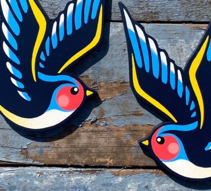 Left and Right versions of Swallows, spray paintings on panels, photographed on weathered painted background.