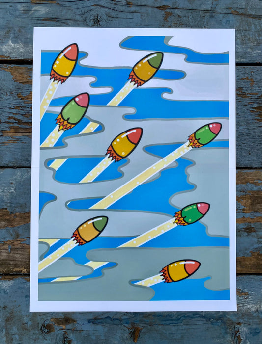 Colorful abstract stencil print depicting launching rockets trailing through clouds or vapor, photographed on a weathered blue wooden background.