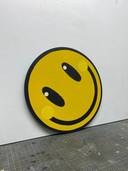 Handmade yellow smiley face wall art on round wooden panel, spray-painted by WallShapes.