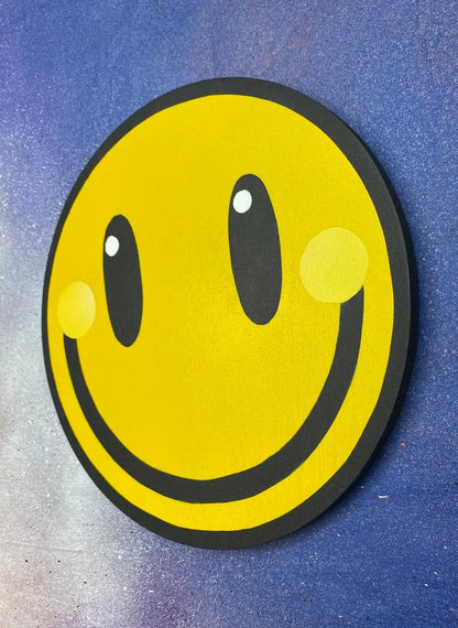 Handmade yellow smiley face spray-painted wall art on a blue background by WallShapes.