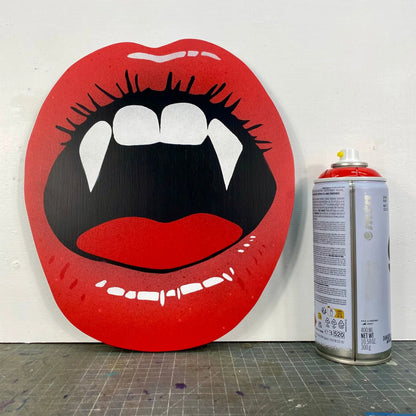 Handmade spray-painted wall art of red vampire lips by WallShapes, shown beside paint can for size comparison.