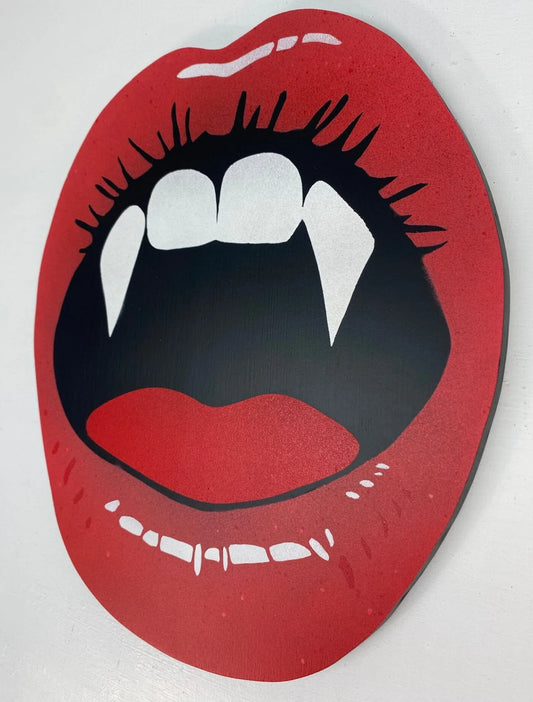 Spray-painted wall art of red lips with vampire fangs, handmade by WallShapes Shop UK.