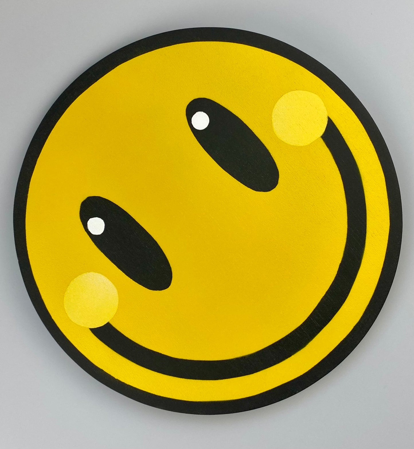 Yellow smiley #1. A spray painting by WallShapes. Hung in alternate position.